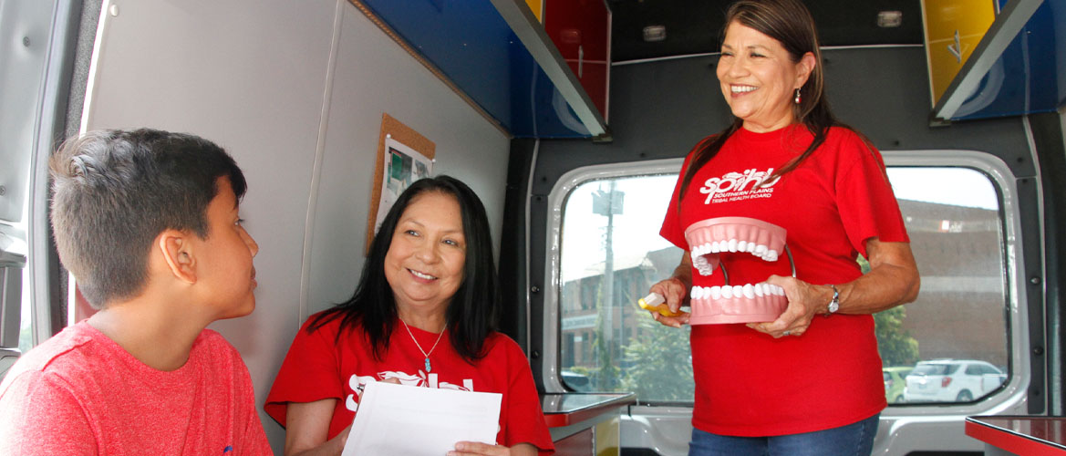 Native American health workers perform screenings in a mobile clinic