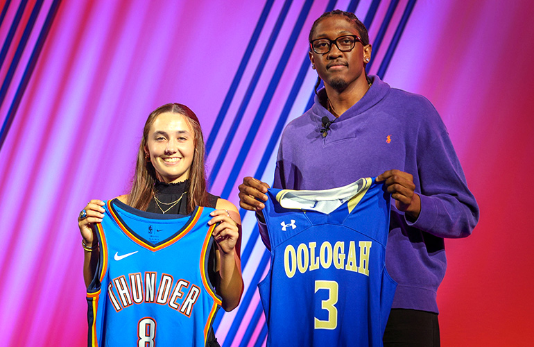 NBA player Jalen Willams in street clothes stands with a high school girl, and each holds up the other's team jersey.  