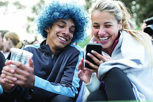 Cute couple looking at mobile phone